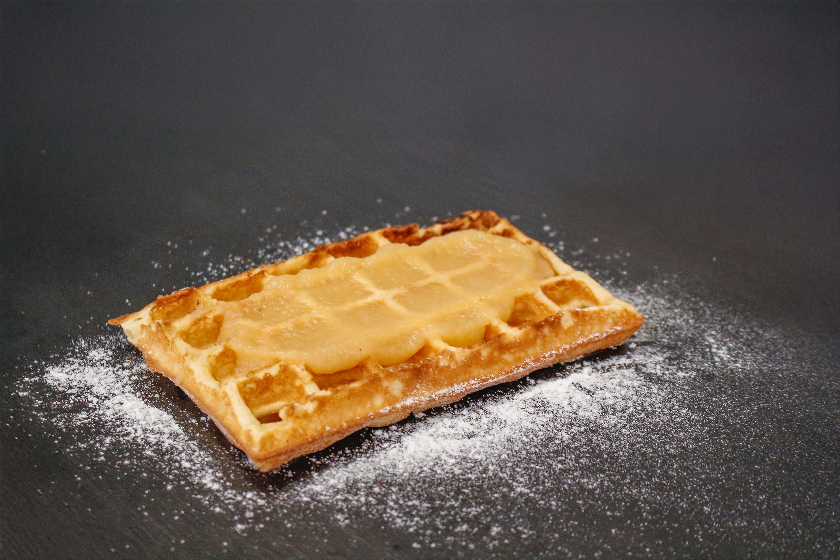 Waffle with applesauce and powdered sugar