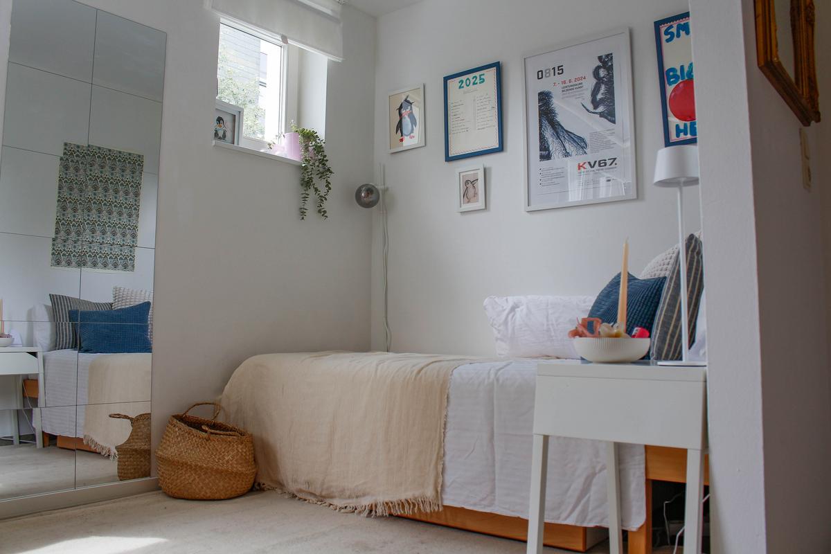 Room with bed, nightstand, and mirror