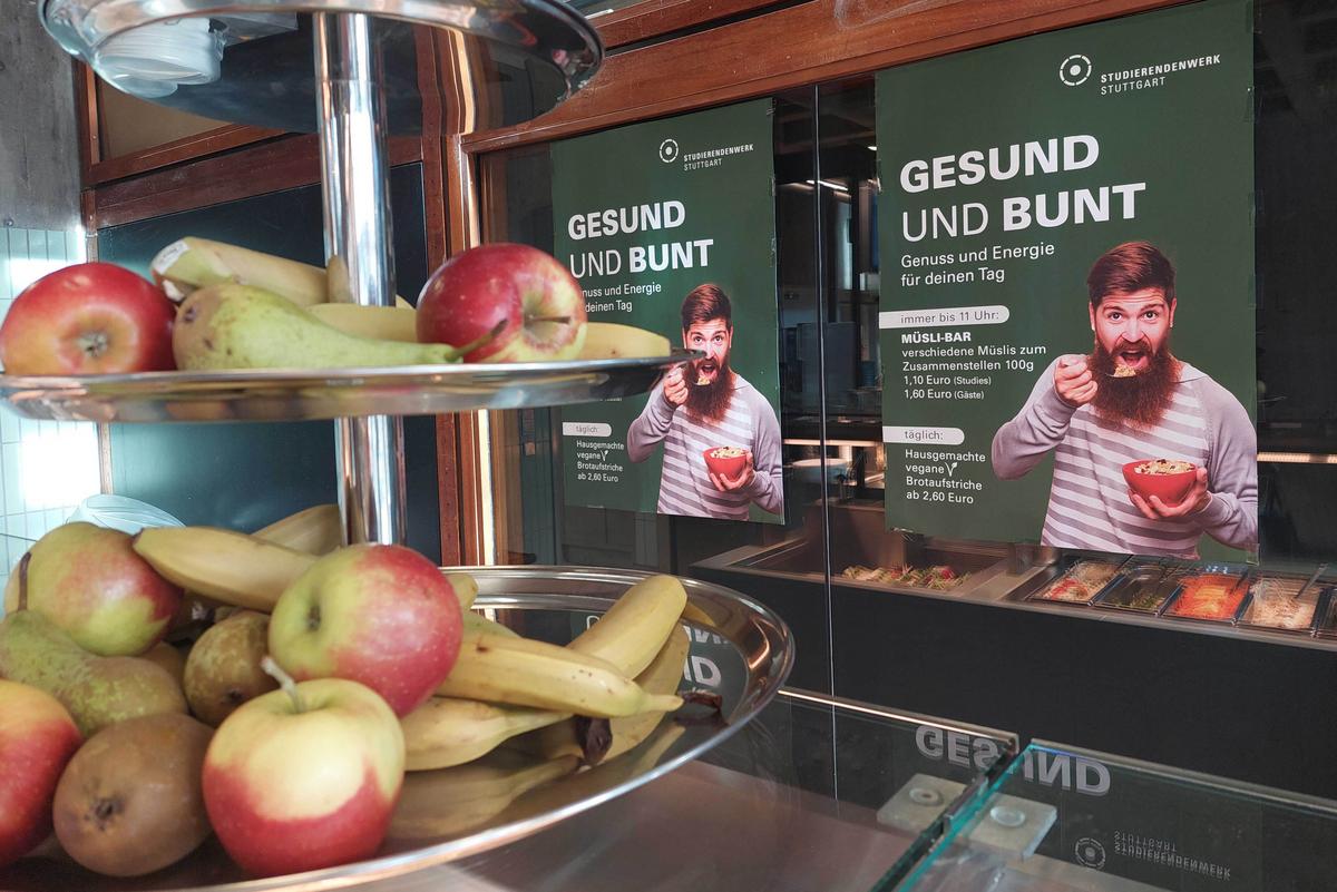 Fruit étagère in the ABK canteen. In the background is a poster advertising the muesli bar daily until 11am
